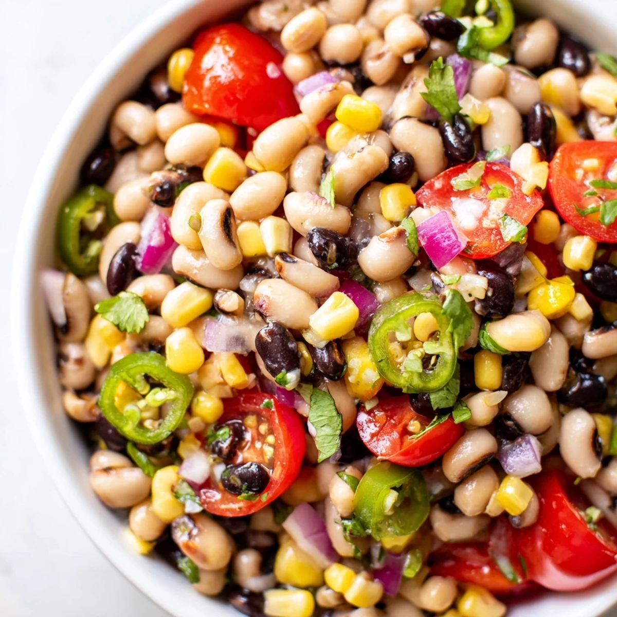 Colorful Cowboy Caviar Recipe glistening with zesty lime dressing and fresh cilantro