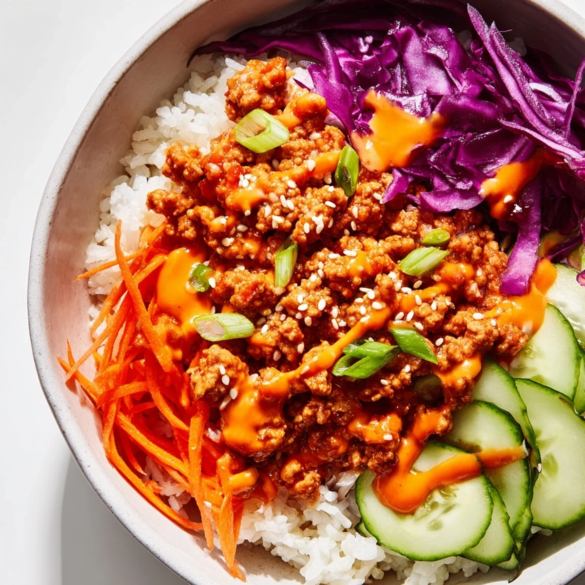 Ground Turkey Rice Bowls drizzled with creamy, spicy Bang Bang Sauce and colorful crisp vegetables