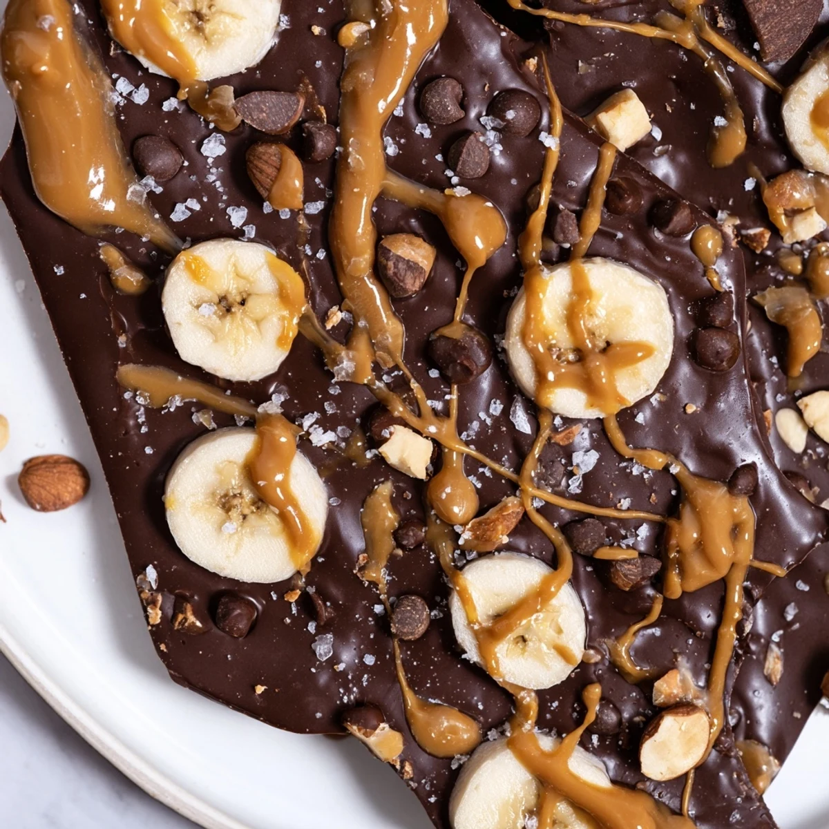 Viral Chocolate Banana Bark topped with crushed nuts and flaky sea salt