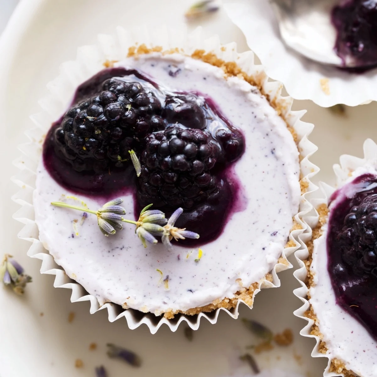 Creamy no bake mini blackberry lavender cheesecakes topped with glossy purple berry sauce
