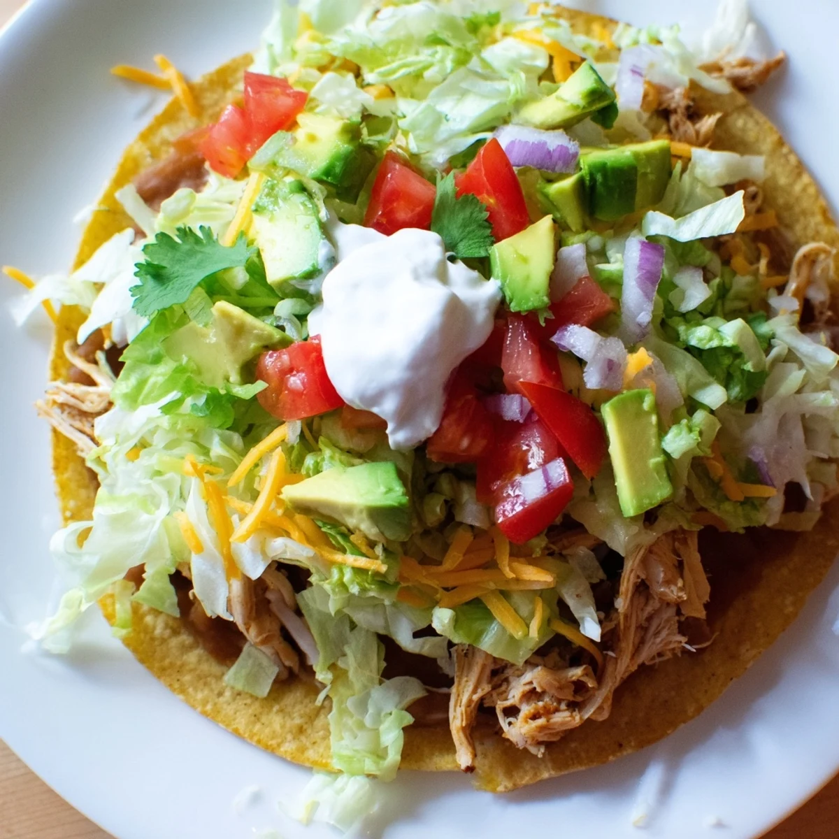 Ultimate chicken tostadas piled with juicy meat and vibrant vegetables.