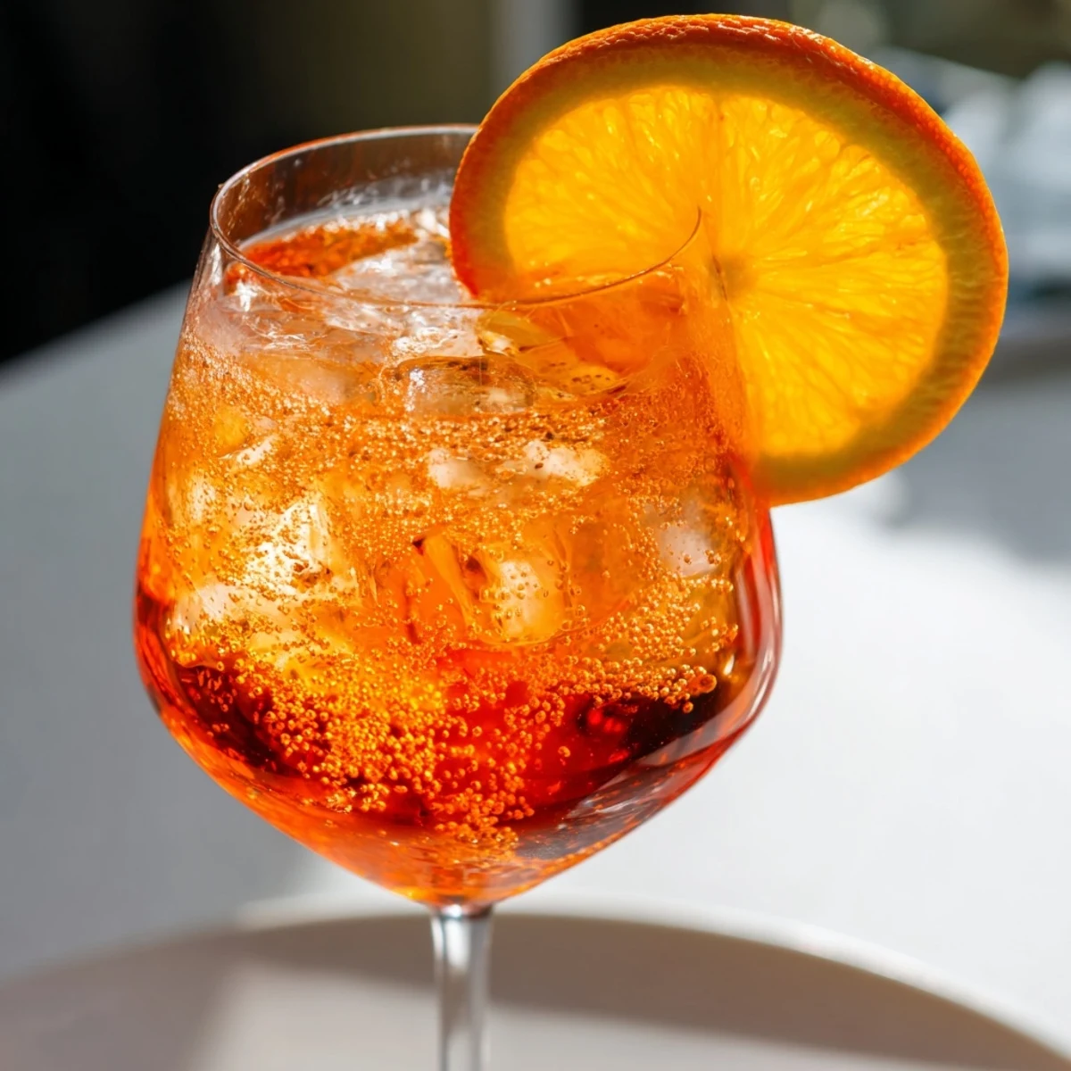 Golden Spritz cocktail served cold with ice, olive garnish, and sparkling effervescence.