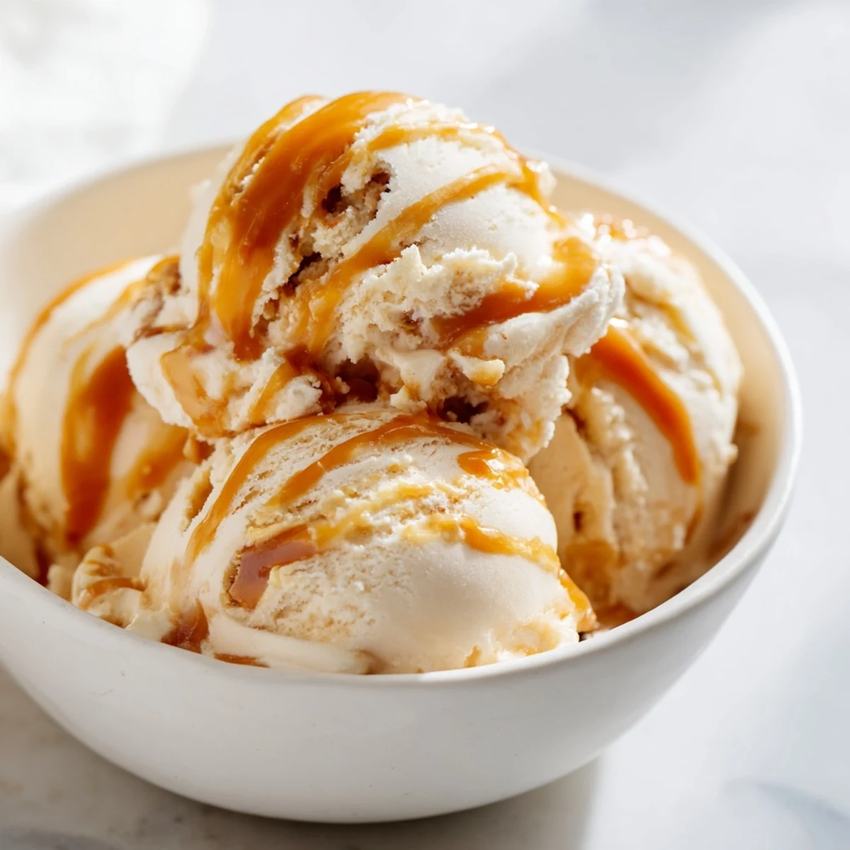 Rich no churn salted caramel ice cream topped with sea salt and sauce.