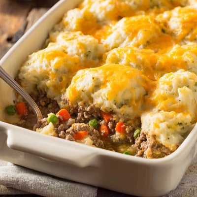 Golden Beef Shepherds Pie with Cheddar Mash bubbling from the oven, served in a rustic dish.